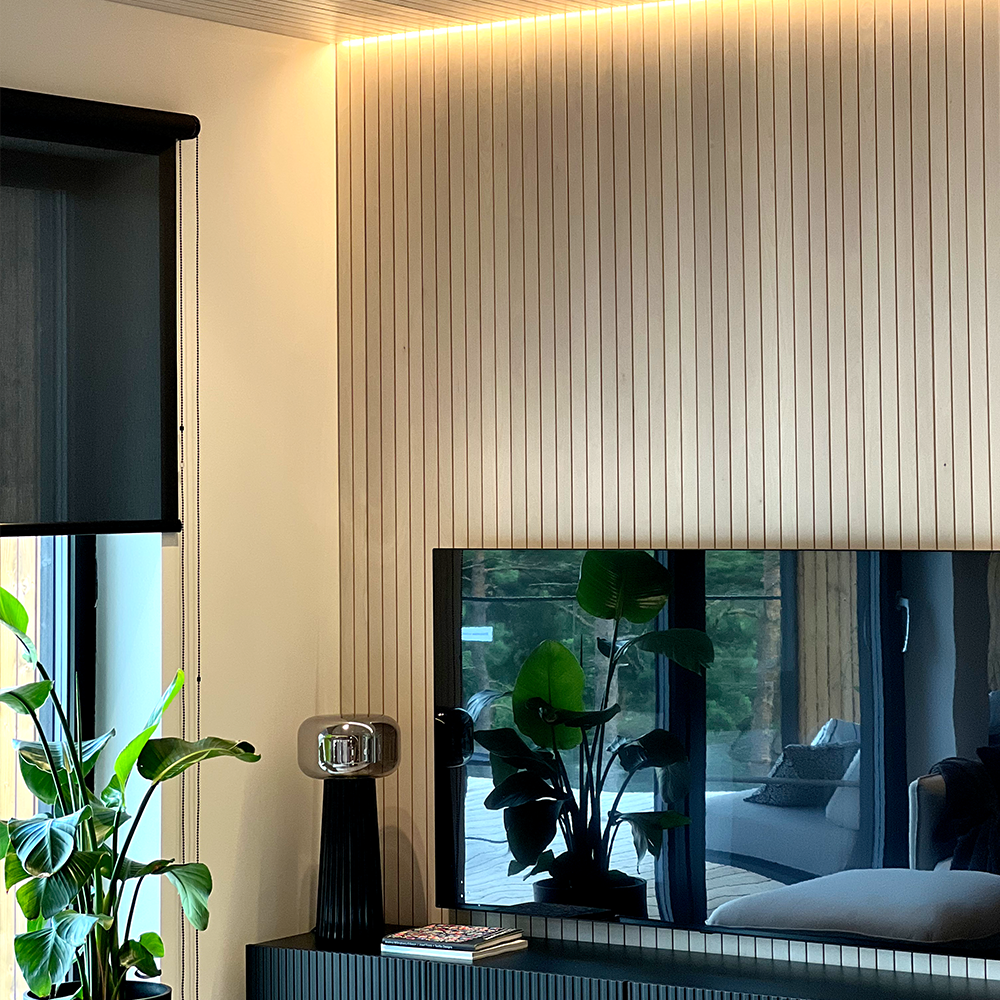 Koivuinen Koo2 interior panels in a translucent white finish on the living room walls and ceiling. Indirect lighting installed between the panels.